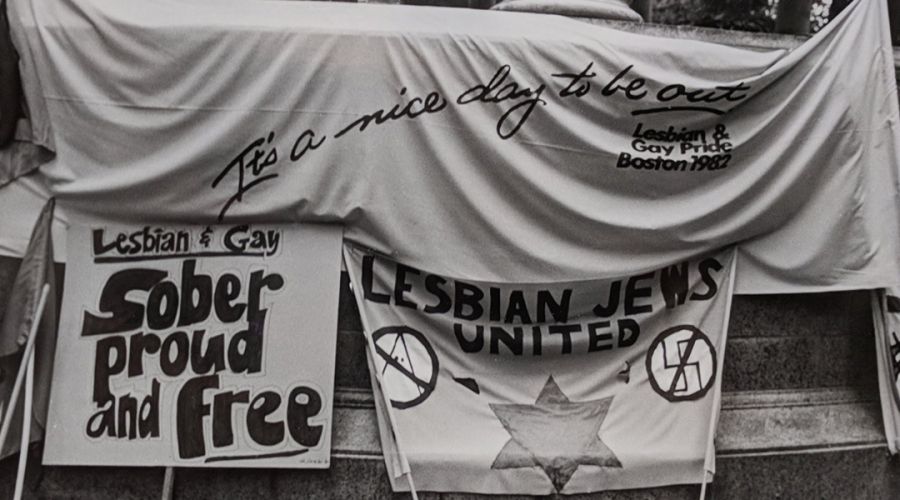 Signs reading It's a Nice Day To Be Out, Lesbian & Gay Sober Proud and Free and Lesbian Jews United Credit: Susan Fleischmann The History Project