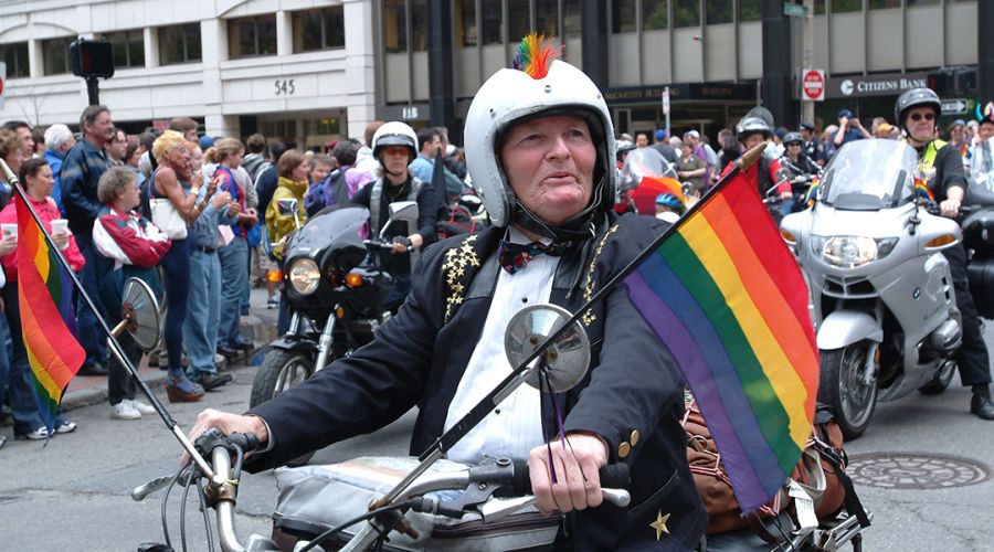 Iconic Lesbian Motorcyclist, Woody Woodward riding her motorcycle down Clarendon St during the Boston Pride Parade